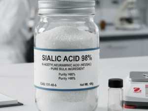 A clear glass jar filled with 98% pure Sialic Acid (N-Acetylneuraminic Acid) powder on a white laboratory desk, with a scientist working in the background.